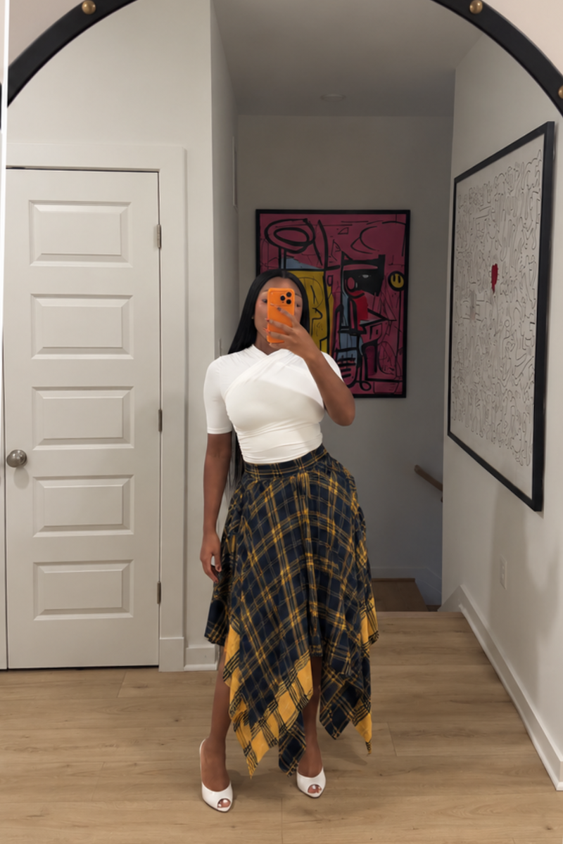 Woman wearing Demuluxe Zora Skirt, a plaid maxi skirt with asymmetric handkerchief hem