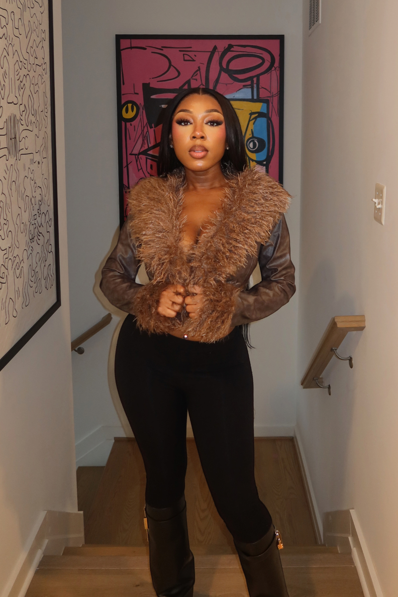 Woman wearing Demuluxe Opal Jacket, a cropped faux fur and leather jacket in brown