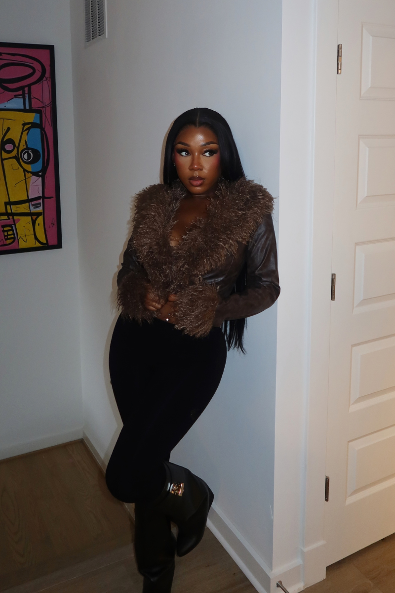 Woman wearing Demuluxe Opal Jacket, a cropped faux fur and leather jacket in brown