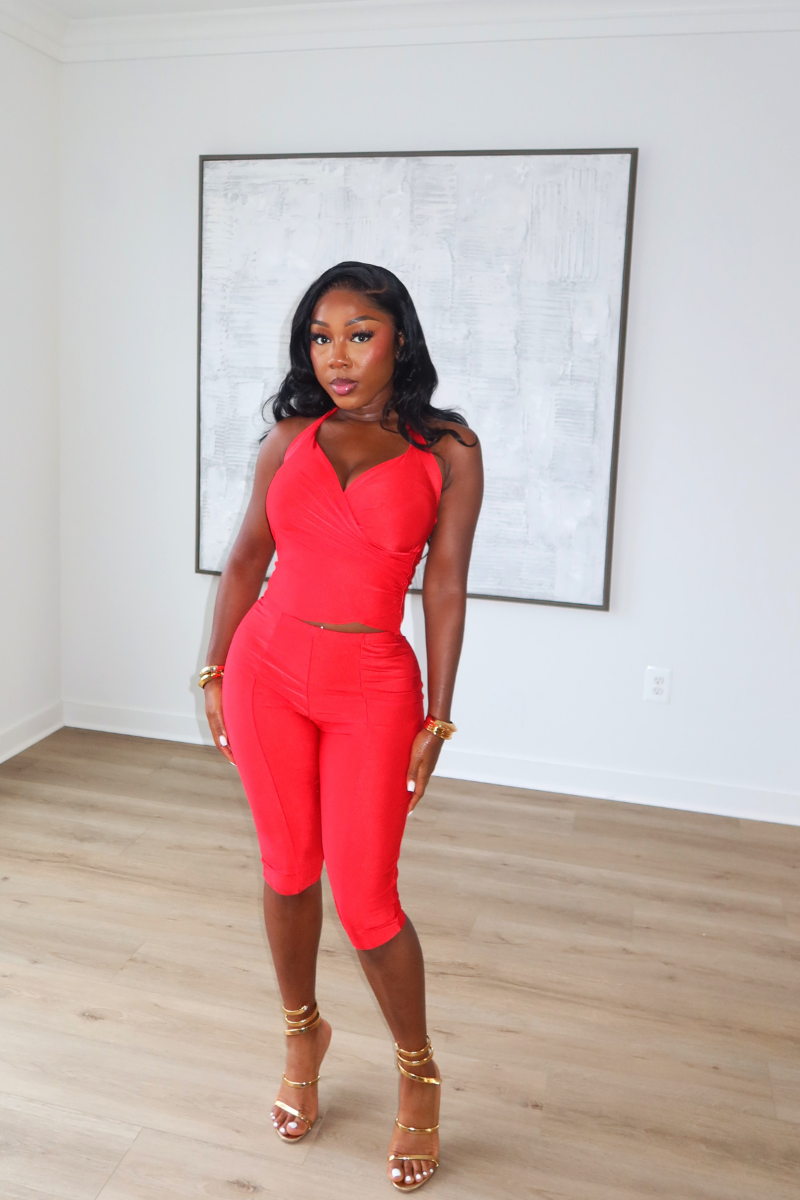 Woman wearing Demuluxe Reya Halter Capri Set, a red crossover halter top with matching high-waisted capri pants