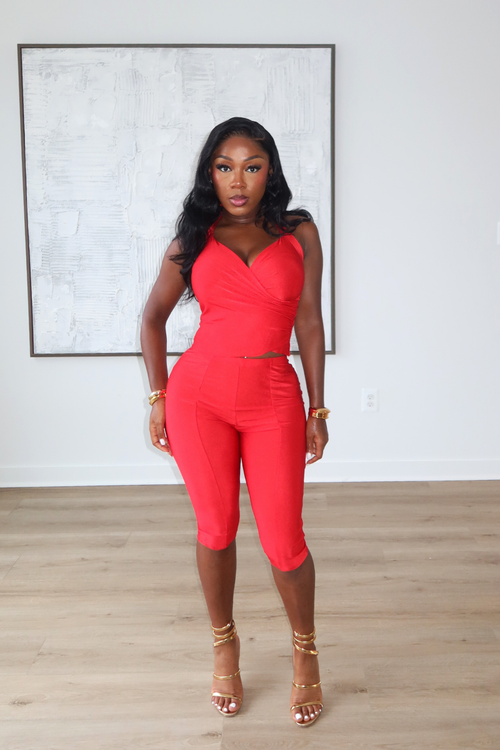 Woman wearing Demuluxe Reya Halter Capri Set, a red crossover halter top with matching high-waisted capri pants