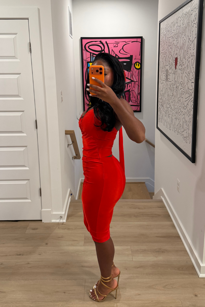 Woman wearing Demuluxe Reya Halter Capri Set, a red crossover halter top with matching high-waisted capri pants