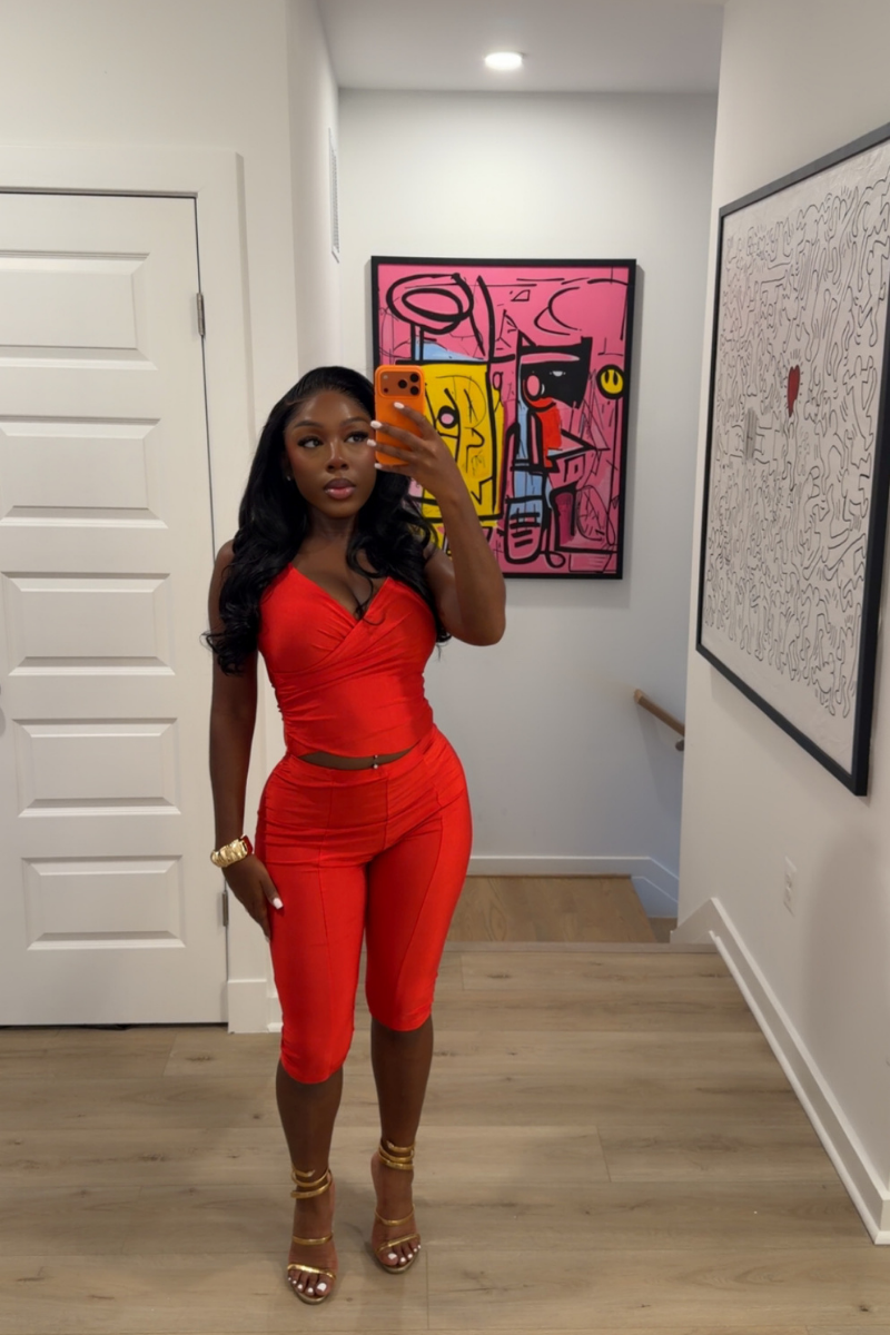 Woman wearing Demuluxe Reya Halter Capri Set, a red crossover halter top with matching high-waisted capri pants