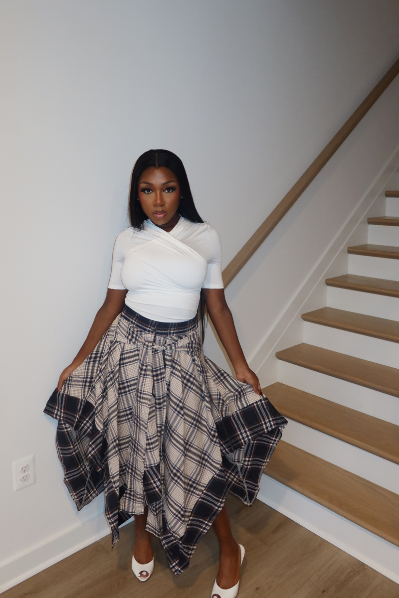Woman wearing Demuluxe Zora Skirt, a plaid maxi skirt with asymmetric handkerchief hem