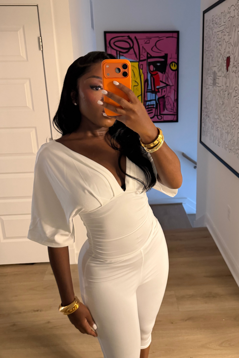 Woman wearing Demuluxe Vale Capri Set, a plunge-neckline two-piece with cinched waist and fitted capri pants