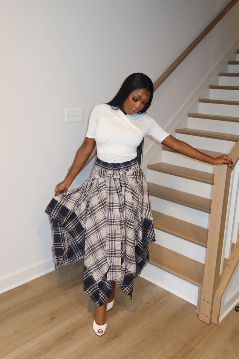 Woman wearing Demuluxe Zora Skirt, a plaid maxi skirt with asymmetric handkerchief hem