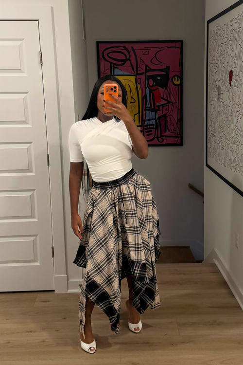 Woman wearing Demuluxe Zora Skirt, a plaid maxi skirt with asymmetric handkerchief hem