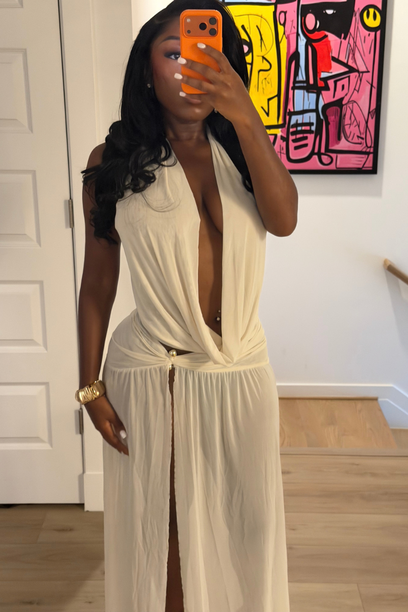 Woman wearing Demuluxe Farrah Skirt Set, a cream draped halter top and matching maxi skirt with front slit