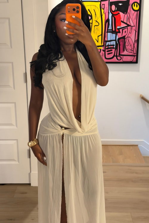 Woman wearing Demuluxe Farrah Skirt Set, a cream draped halter top and matching maxi skirt with front slit
